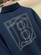 Blue polo shirt back with large TB monogram graphic, embroidered lines
