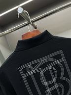 Black polo shirt back graphic with outlined lettering and number-style design.