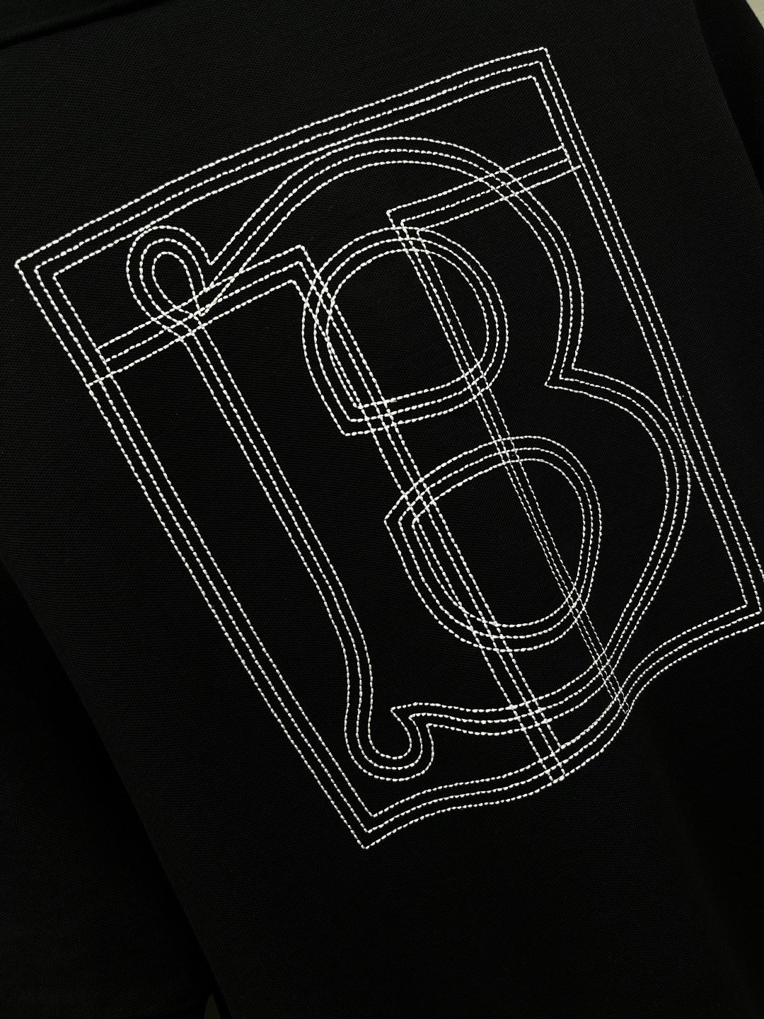 Black polo shirt back graphic print with outlined letters and number-style design.