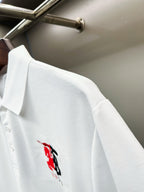 Burberry white polo with small red/black logo on chest area