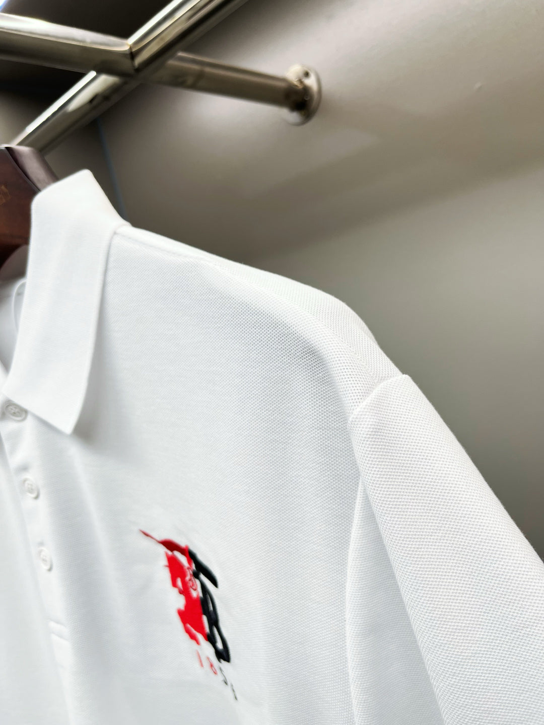 Burberry white polo with small red/black logo on chest area