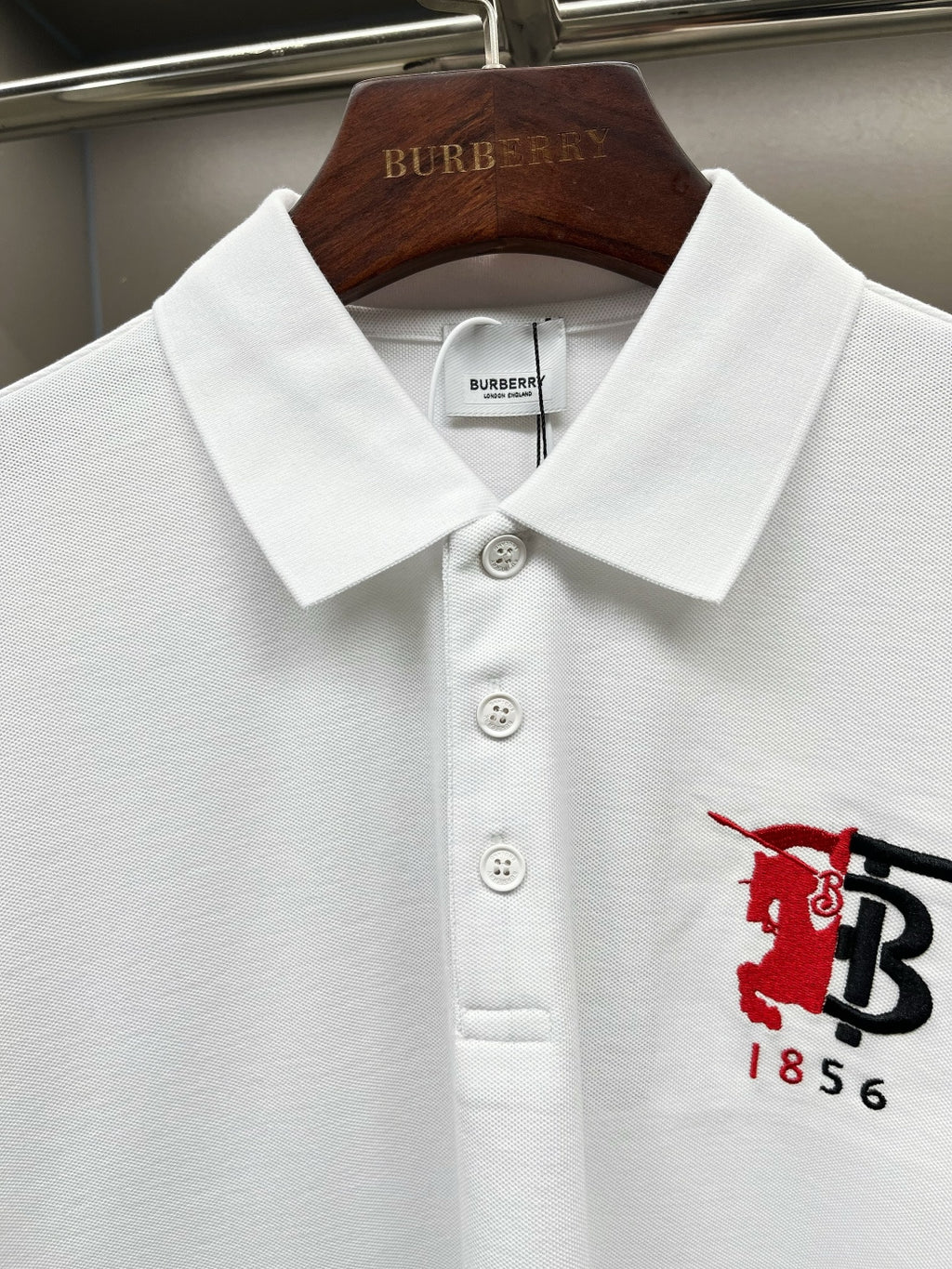 Burberry white polo shirt with button placket and red/black 1856 logo on chest