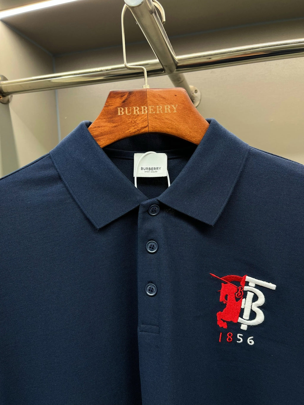 Dark blue polo shirt with red and white chest logo