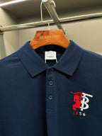 Dark blue polo shirt with red and white chest logo