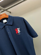 Dark blue polo shirt with red and white chest logo on front