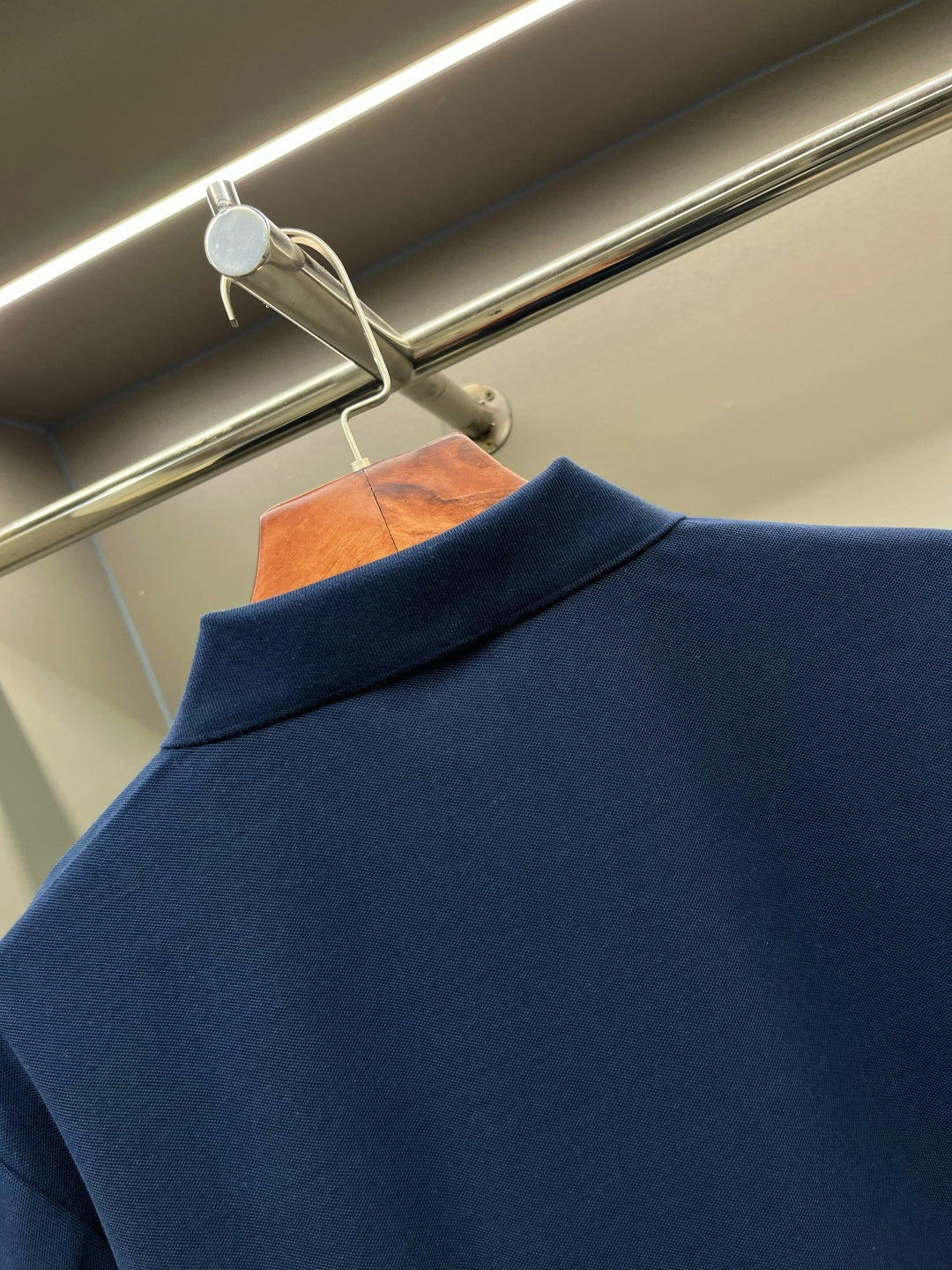 Dark blue polo shirt with ribbed collar and neckline