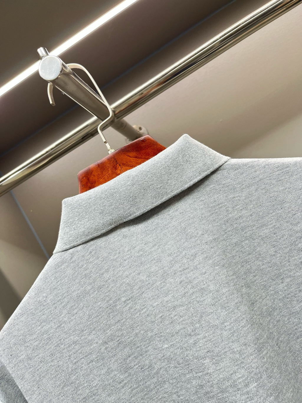 Light gray polo shirt shoulder with folded collar