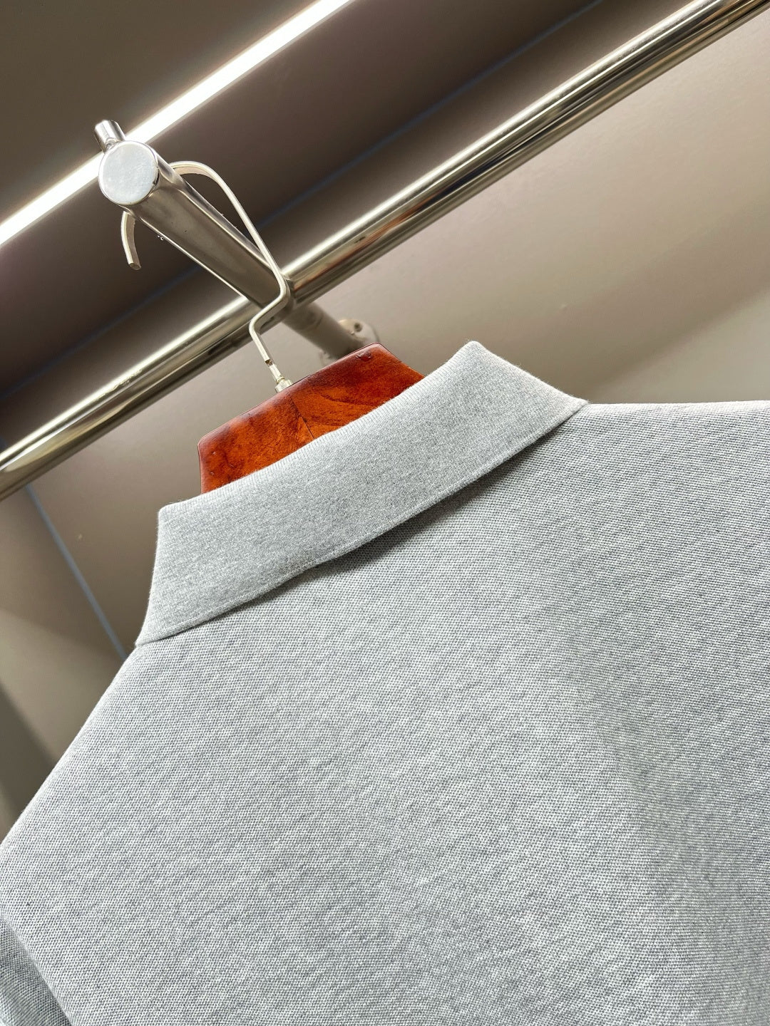 Light gray polo shirt shoulder with folded collar