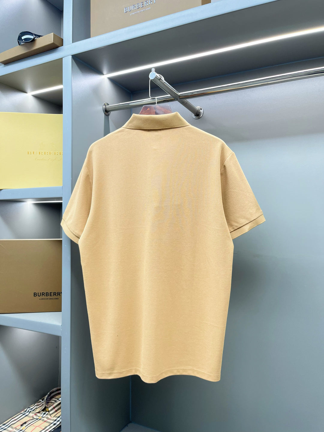 Beige polo shirt back view with buttoned collar, short sleeves