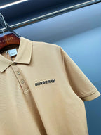 Beige polo shirt close-up of Burberry logo on chest, collared neckline