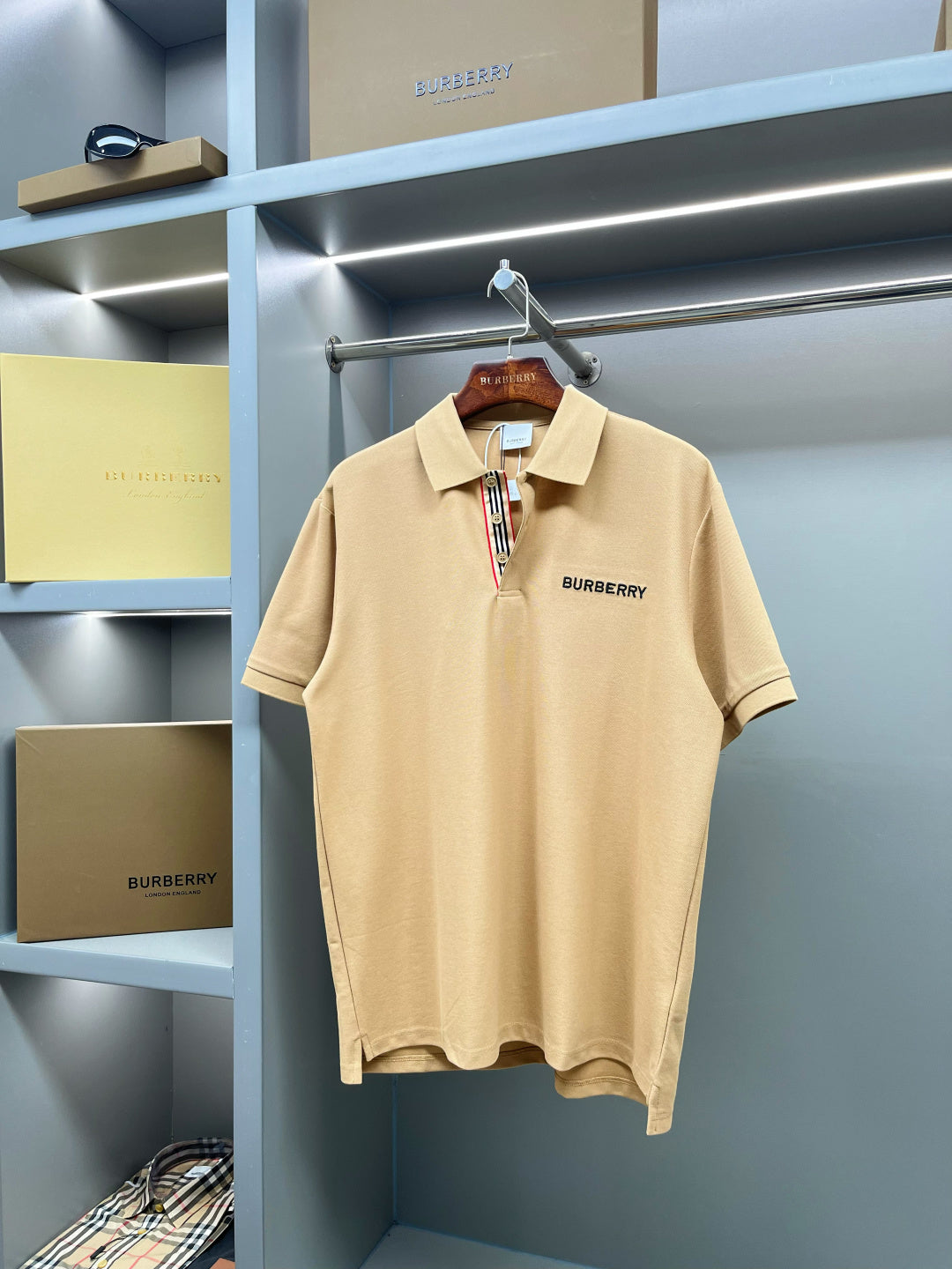 Beige polo shirt front view with Burberry logo, buttoned collar, short sleeves