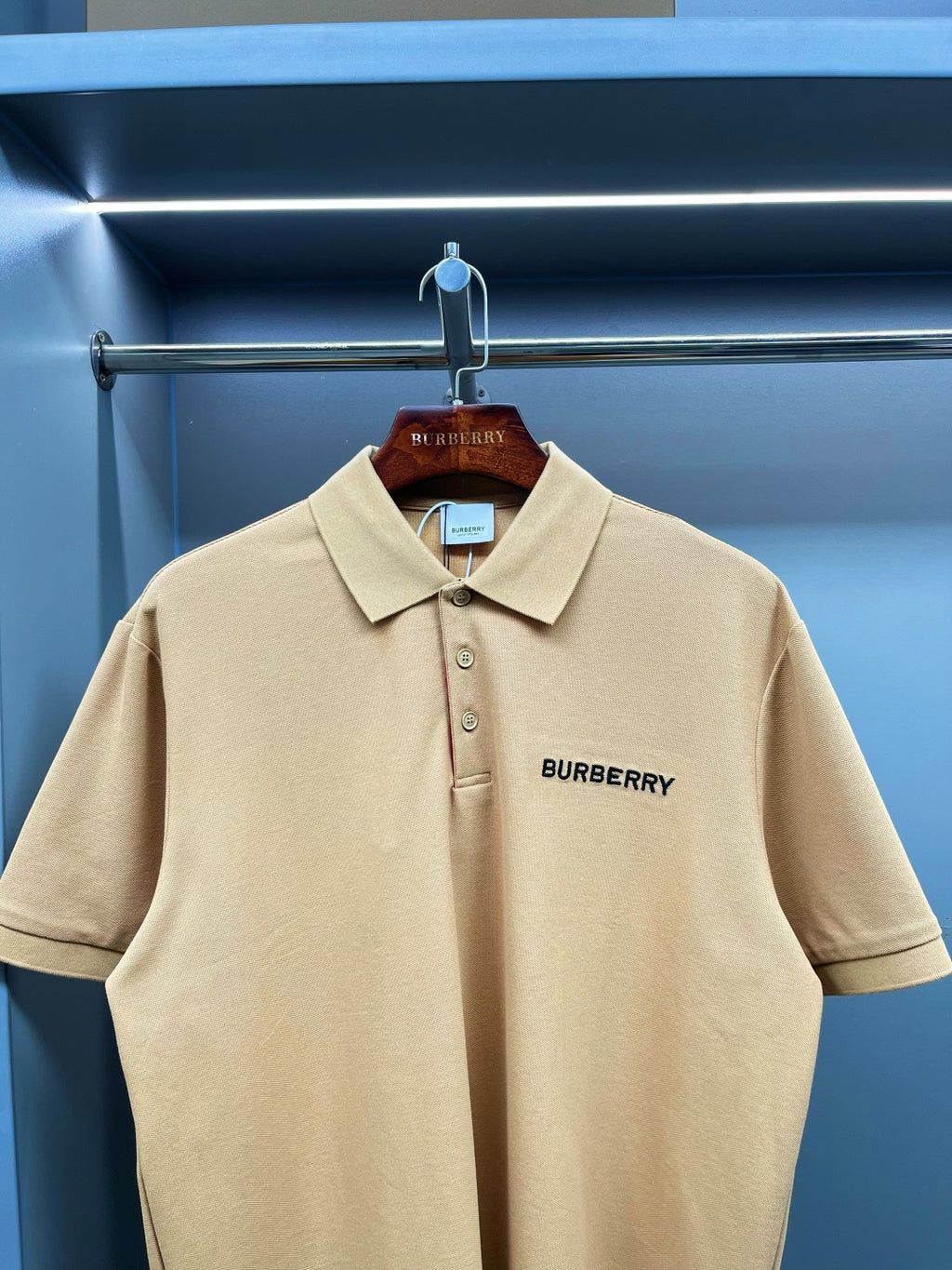 Beige polo shirt with Burberry logo on chest and three-button placket, short sleeves