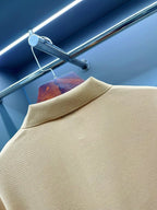 Beige polo shirt collar close-up with textured fabric and short sleeves