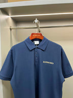 Blue Burberry polo shirt with fold-over collar and small chest logo