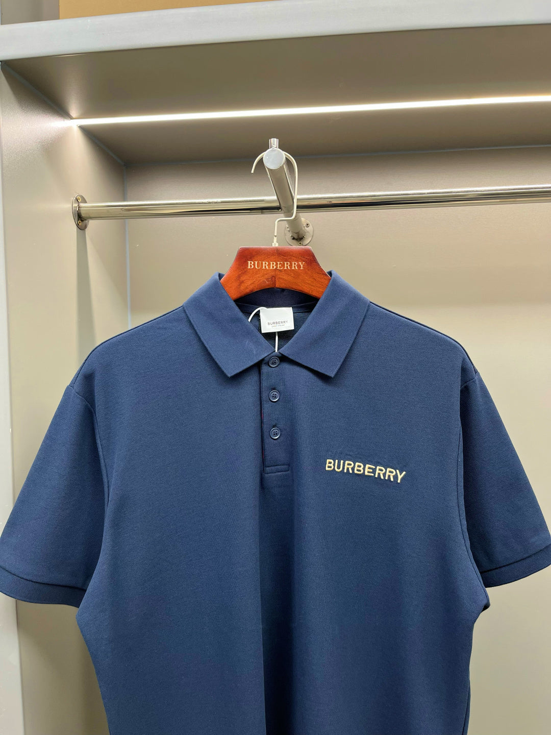 Blue Burberry polo shirt with fold-over collar and small chest logo