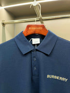 Close-up of blue Burberry polo shirt chest logo and button placket
