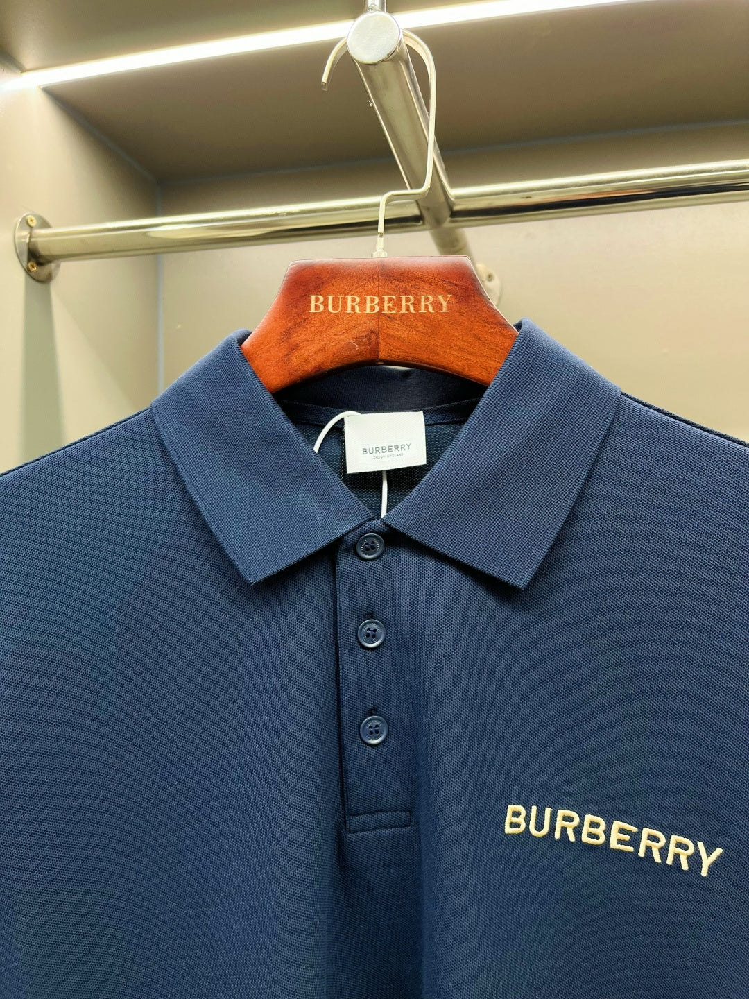 Close-up of blue Burberry polo shirt chest logo and button placket
