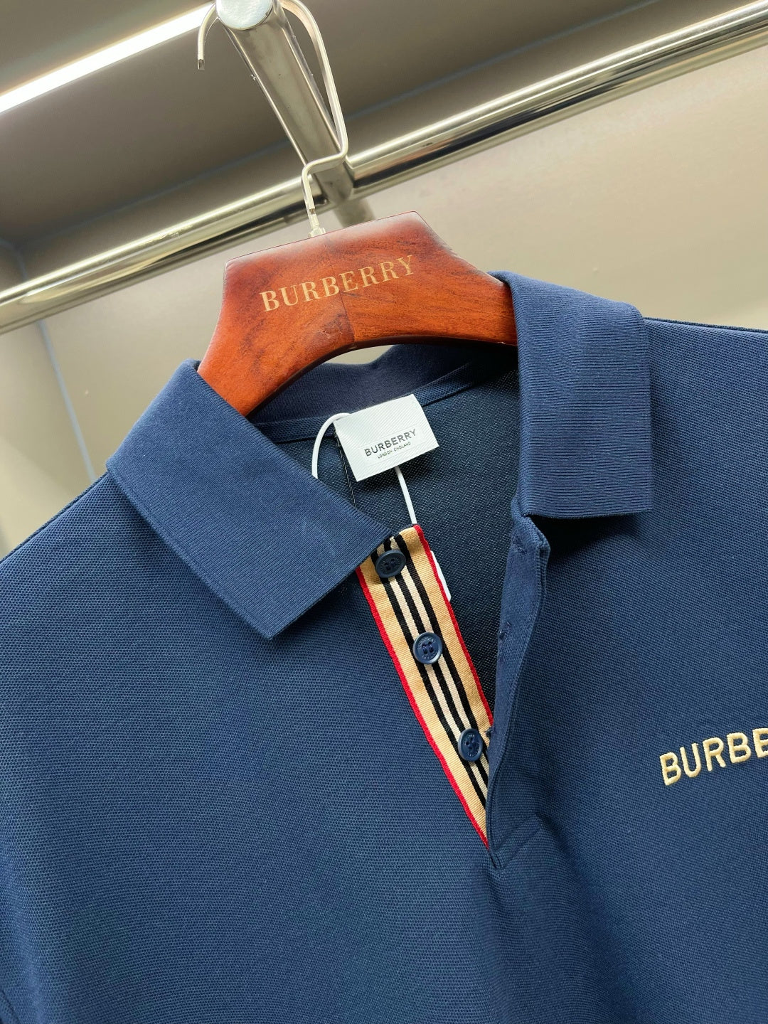 Blue polo shirt collar with button placket and Burberry embroidery