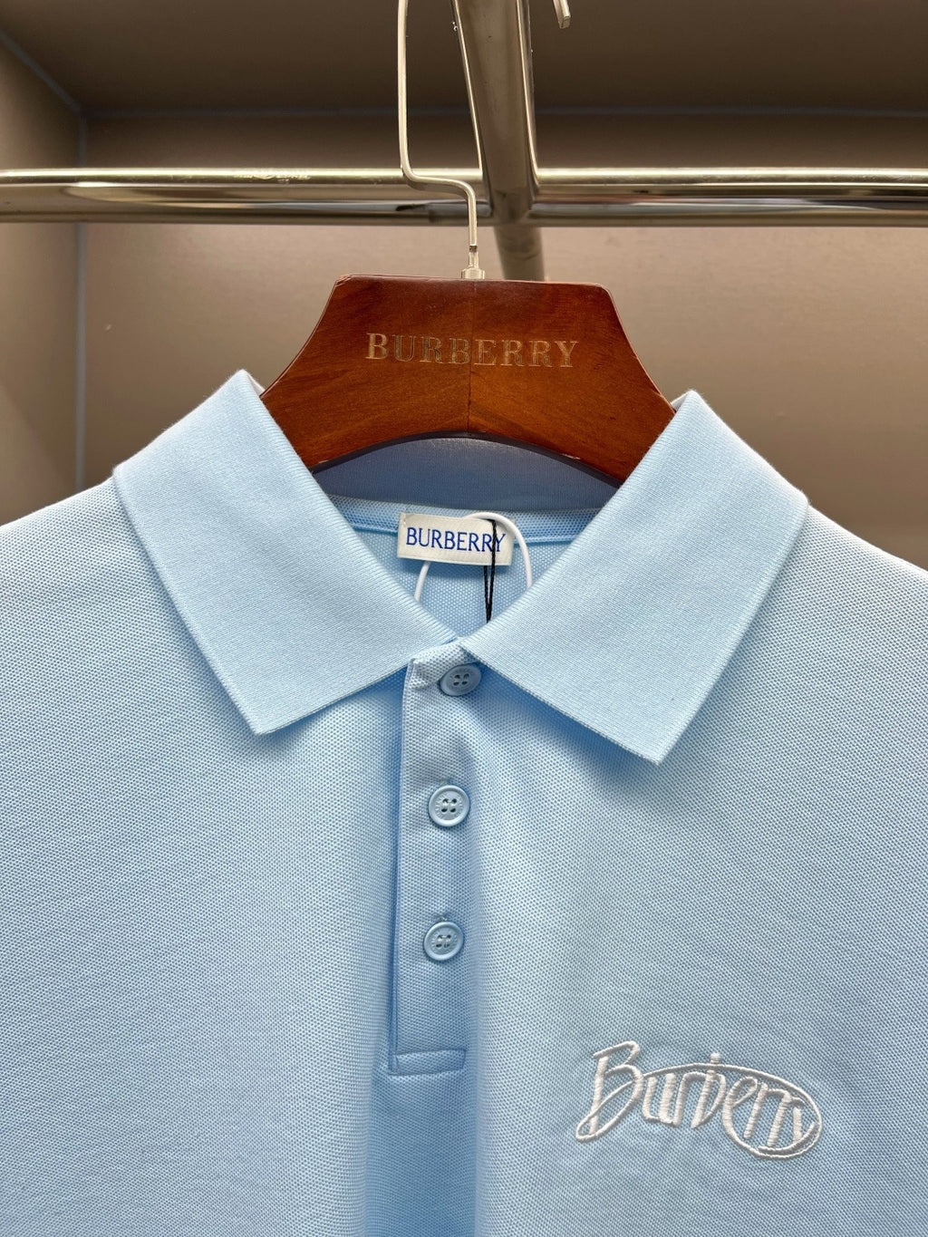 Burberry light blue polo shirt collar and button placket with embroidered chest logo