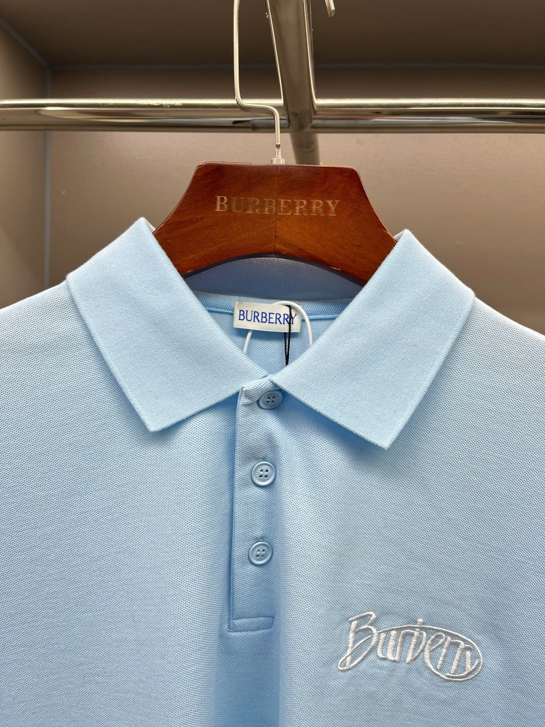 Burberry light blue polo shirt collar and button placket with embroidered chest logo