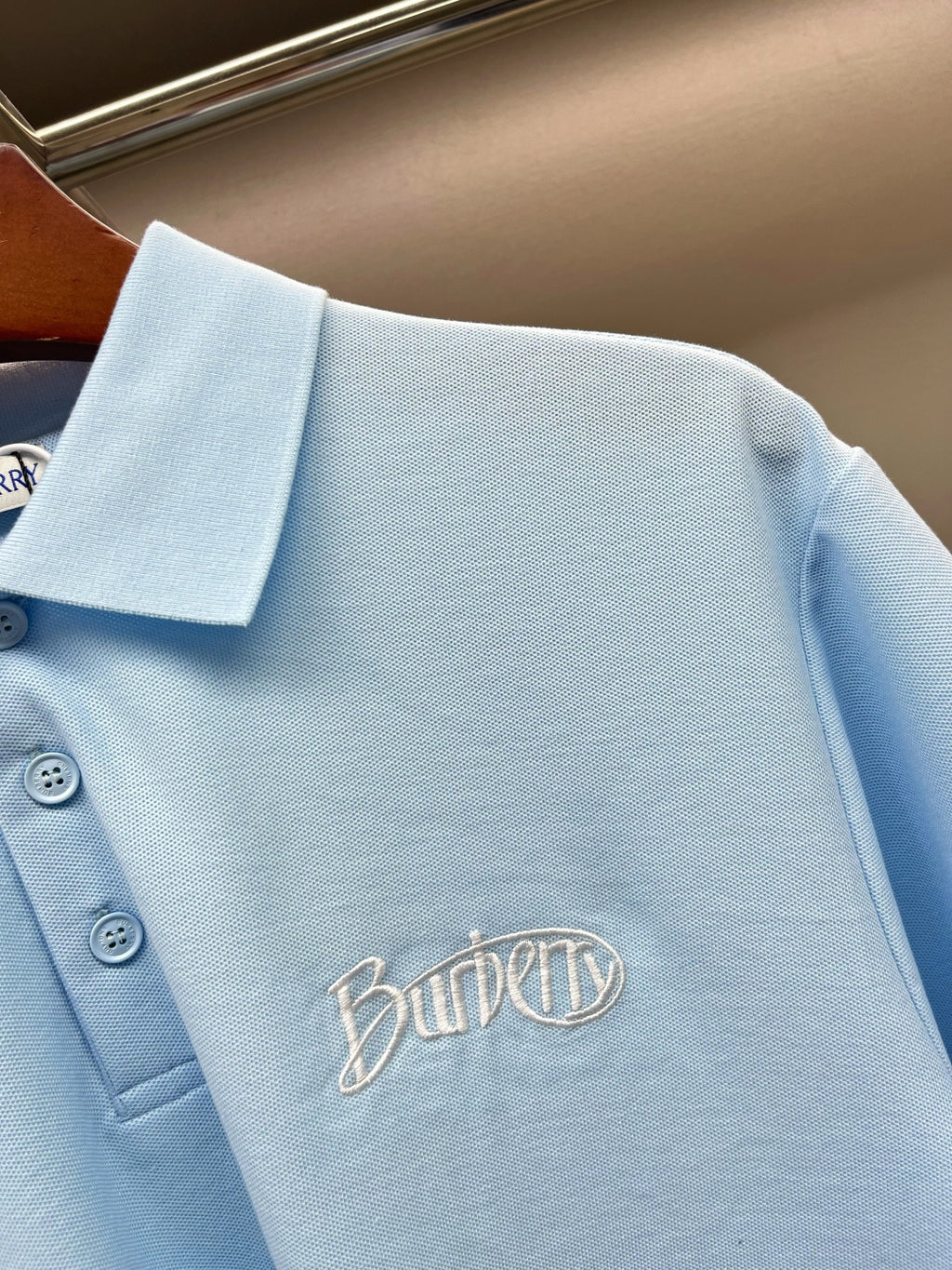 Burberry light blue polo shirt with embroidered script logo on the chest