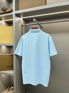 Burberry light blue short-sleeve polo shirt, back view on a hanger
