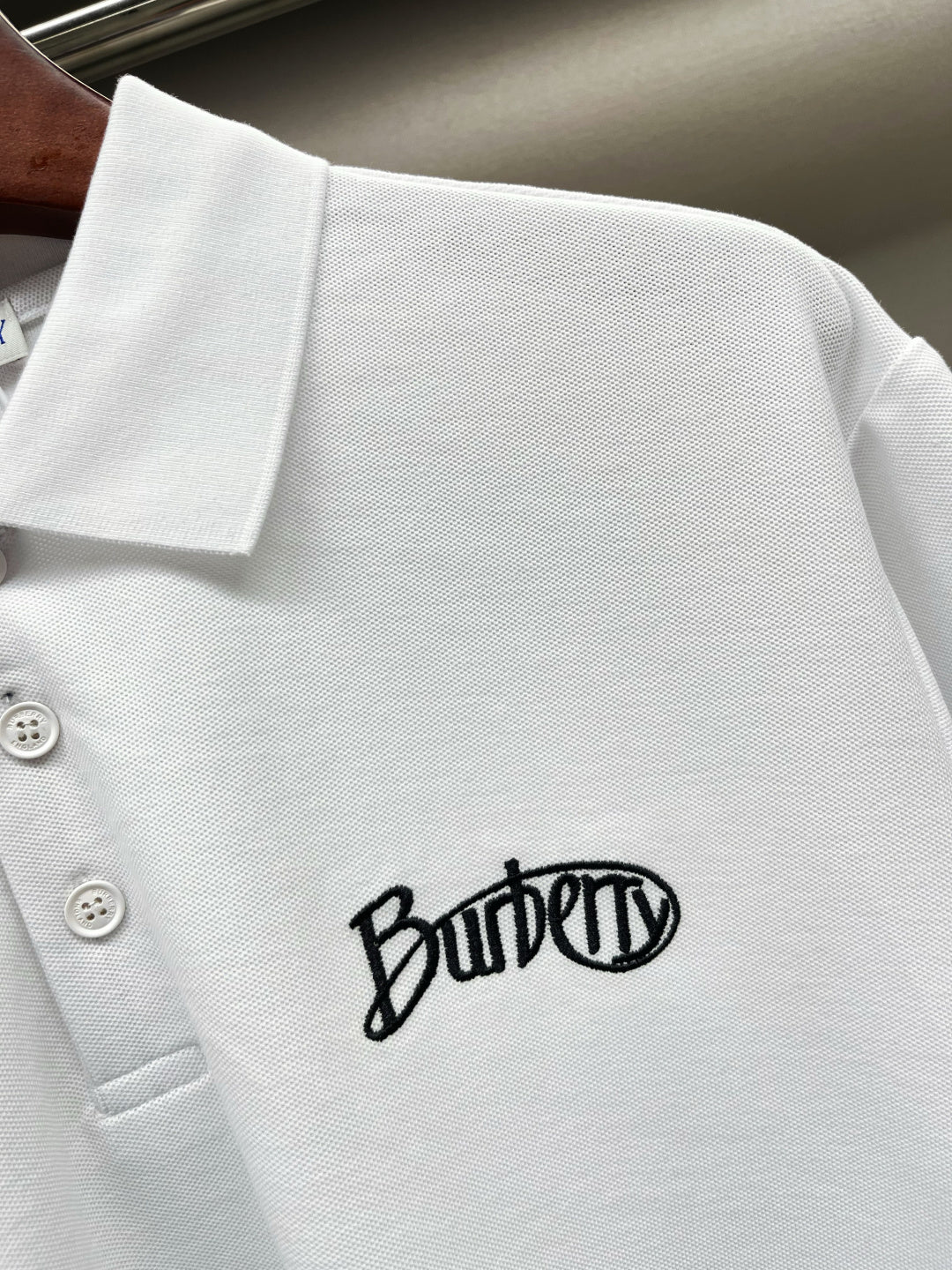 Burberry white short-sleeve polo shirt close-up of chest logo on knit fabric