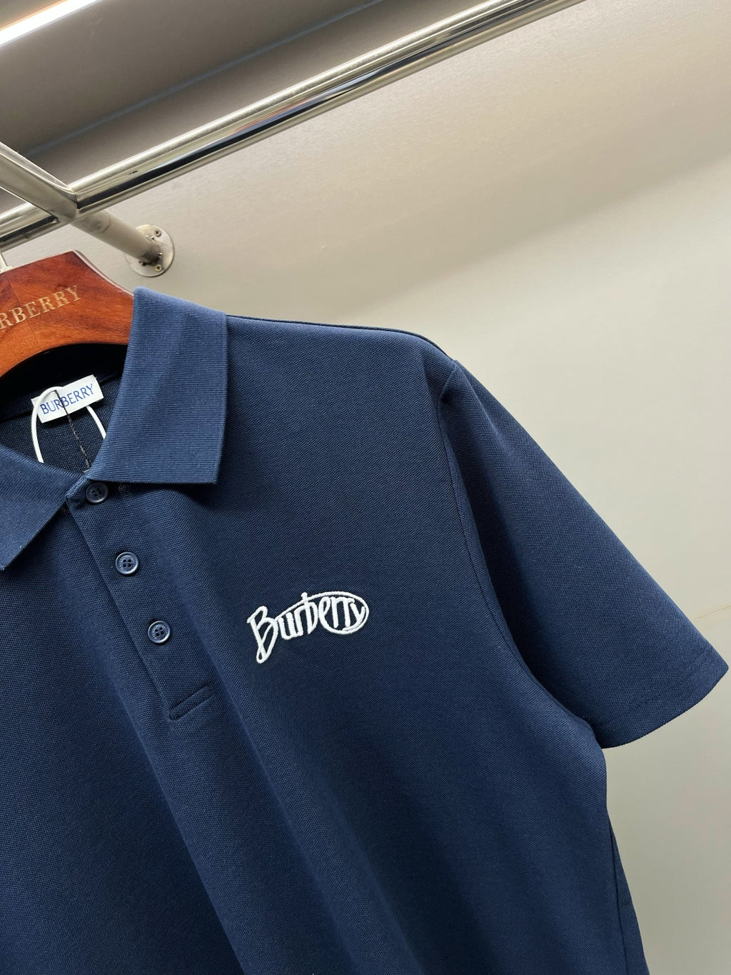 Navy Burberry polo shirt with chest logo, short sleeves, button placket