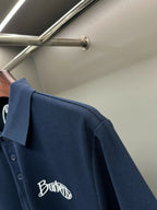 Navy Burberry polo shirt sleeve with embroidered Burberry logo on front