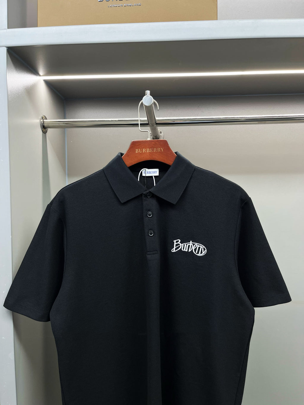 Dark navy short-sleeve polo shirt with button placket and embroidered Burberry logo