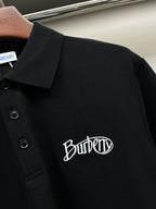 Black polo shirt close-up with three-button placket and Burberry logo embroidery