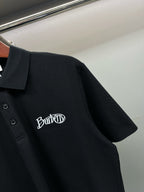 Black polo shirt side view with embroidered Burberry logo on chest