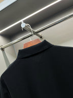 Back of dark navy polo shirt with wide collar and no visible front print