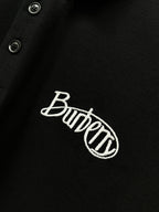 Black polo shirt fabric close-up with Burberry embroidered logo and button