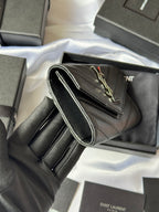 Dark small bag with front flap, visible interior and handle strap