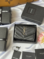 Dark small bag with chevron quilting and YSL gold logo on front flap
