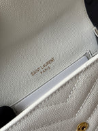 Small bag close-up in light cream with Saint Laurent Paris embossed on strap