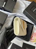 Small bag in light cream with wrist handle, front flap, and gold Saint Laurent logo