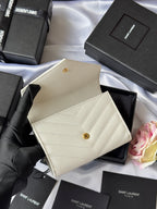 Small bag in light cream with gold Saint Laurent logo, shown from angled views