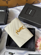 Small bag in light cream with quilted front and gold Saint Laurent logo