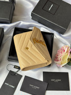 Small bag wallet in light yellow textured leather with YSL logo, open box display