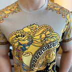 Versace T-shirt close-up showing gold baroque portrait and Greek key trim on chest