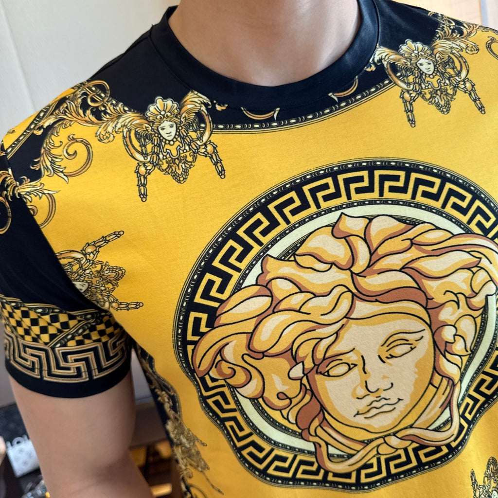 Gold and black T-shirt with Medusa-style face print and Greek key border