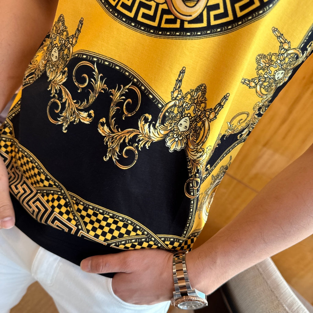 Gold and black T-shirt hem with ornate scroll pattern and Greek key border