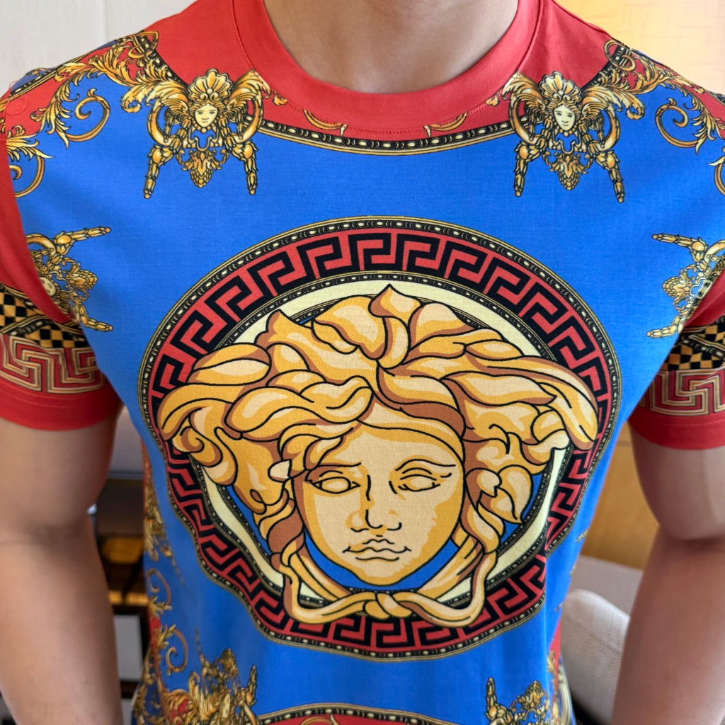 Versace T-shirt close-up of gold face medallion inside a patterned border
