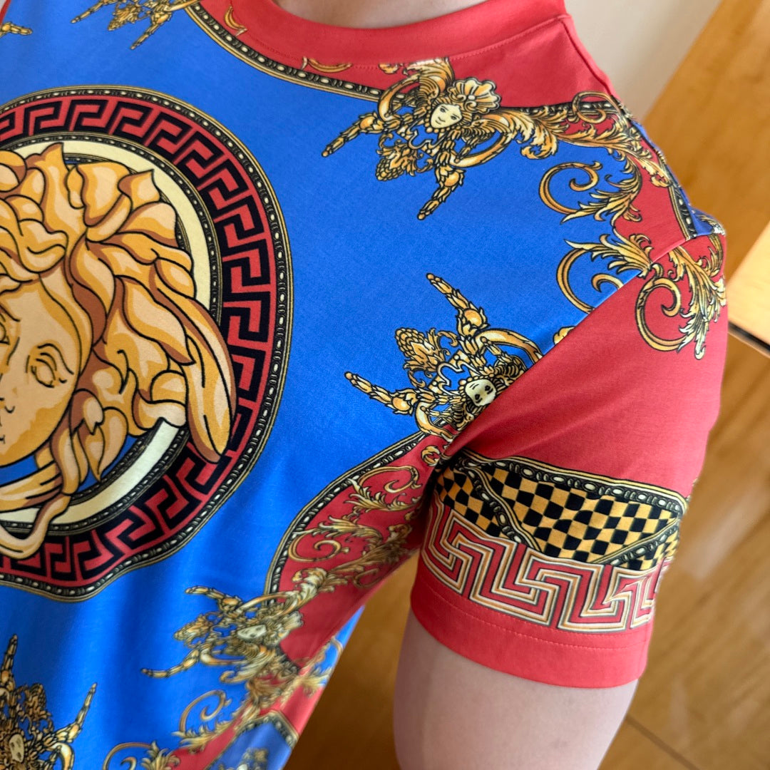 Versace T-shirt sleeve detail with blue-and-red scroll pattern and gold accents