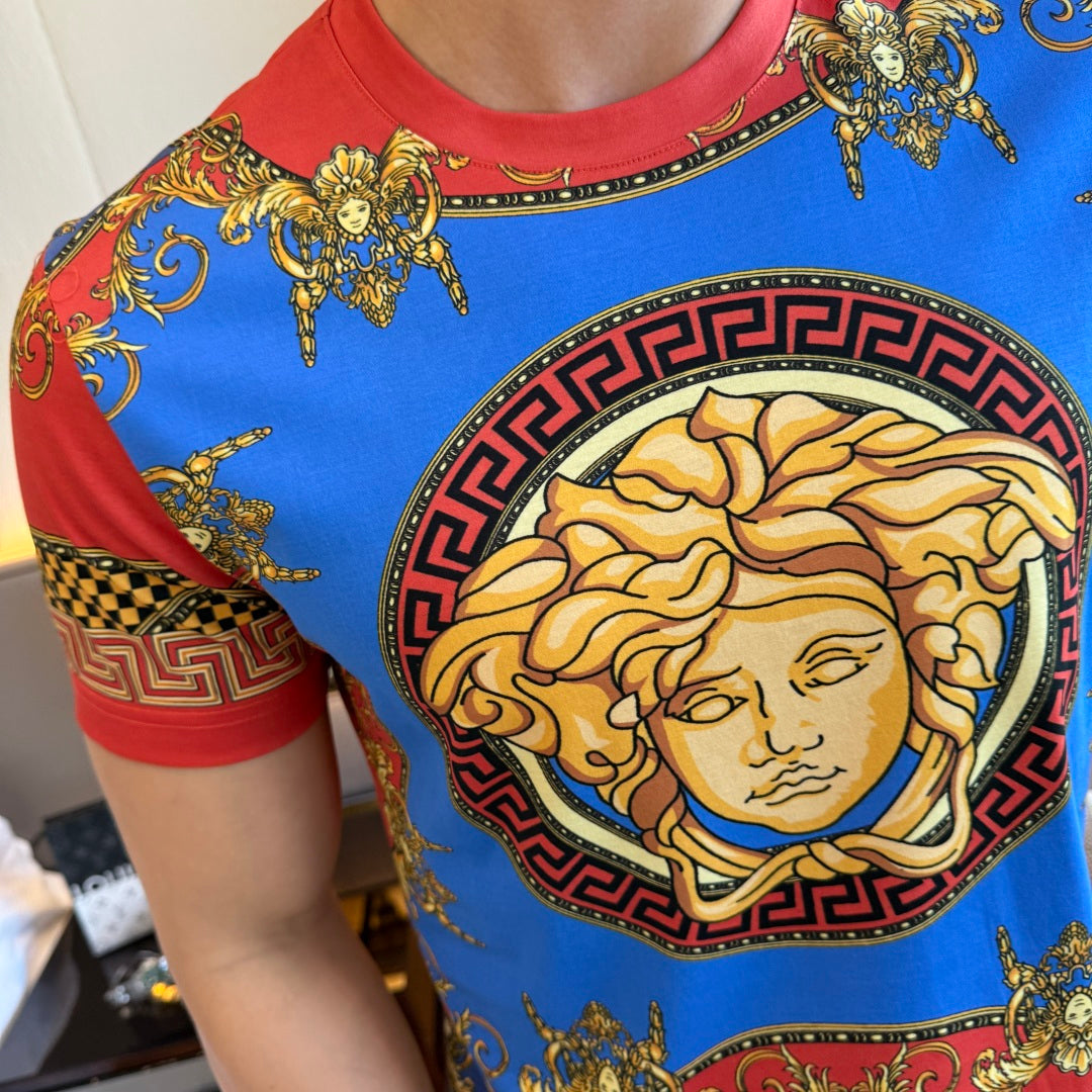 Versace T-shirt close-up with blue fabric, red trim, and gold face medallion