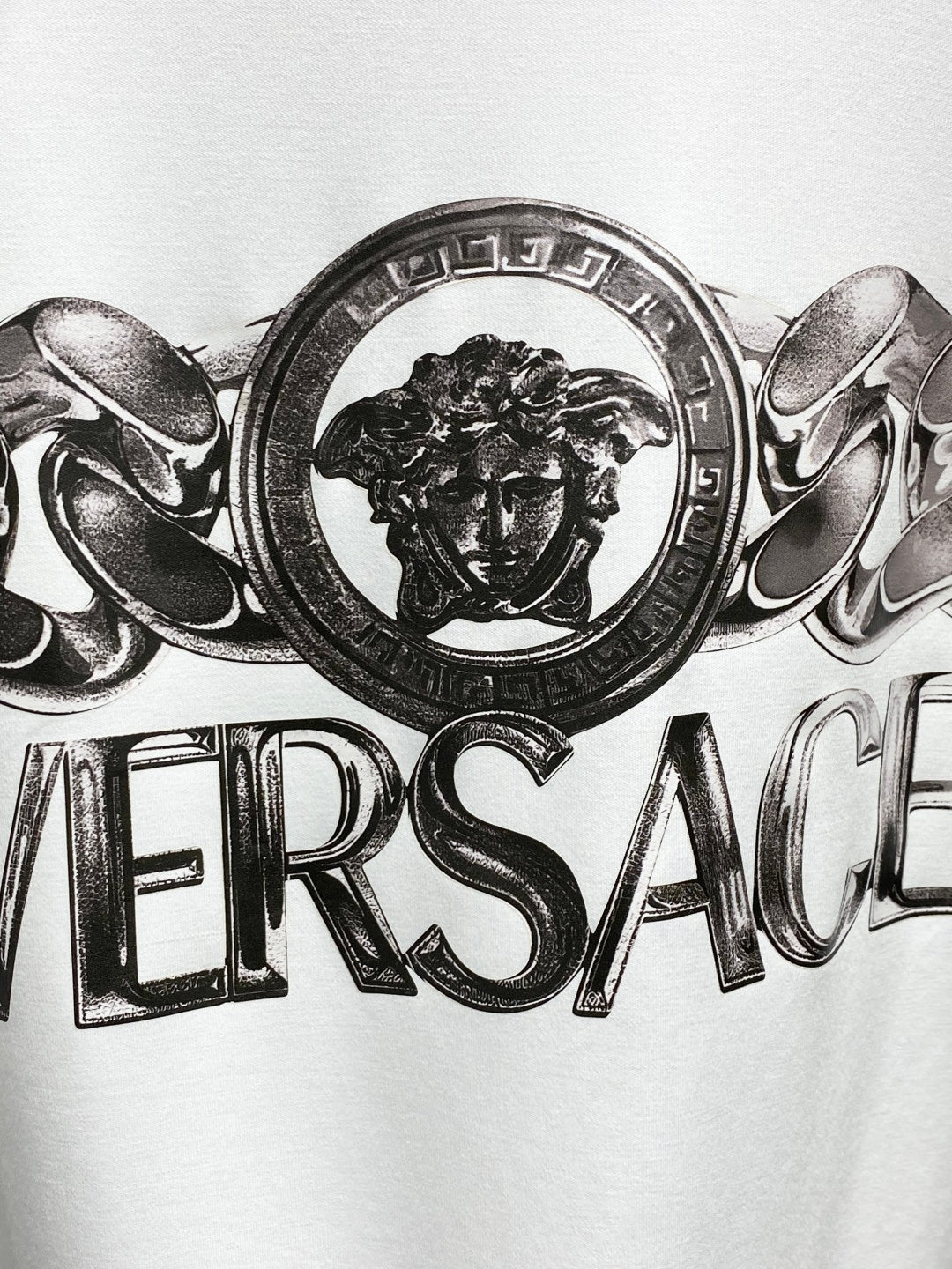 Versace white crewneck T-shirt close-up of lion crest medallion logo