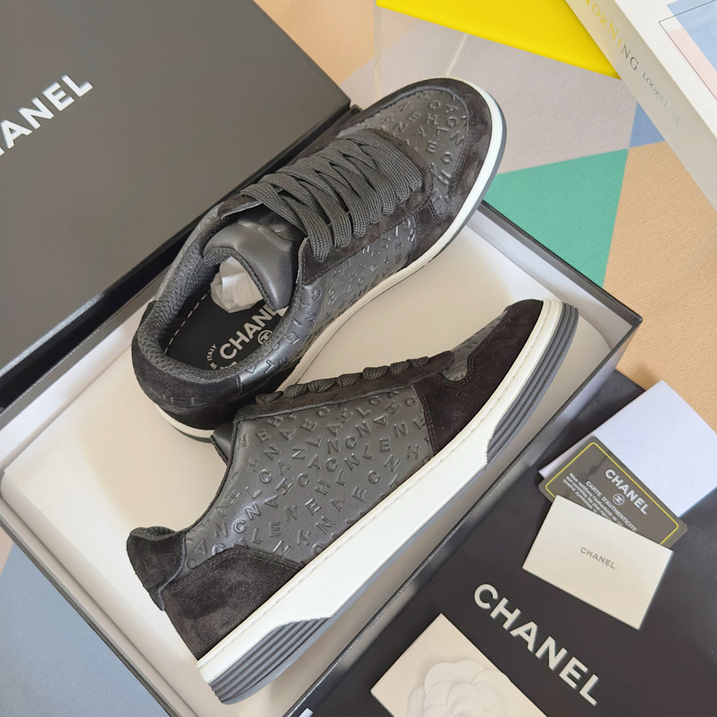 Black Chanel lace sneakers in box, white midsoles and textured logo uppers