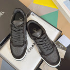 Black Chanel lace-up sneakers with textured logo upper and padded collar